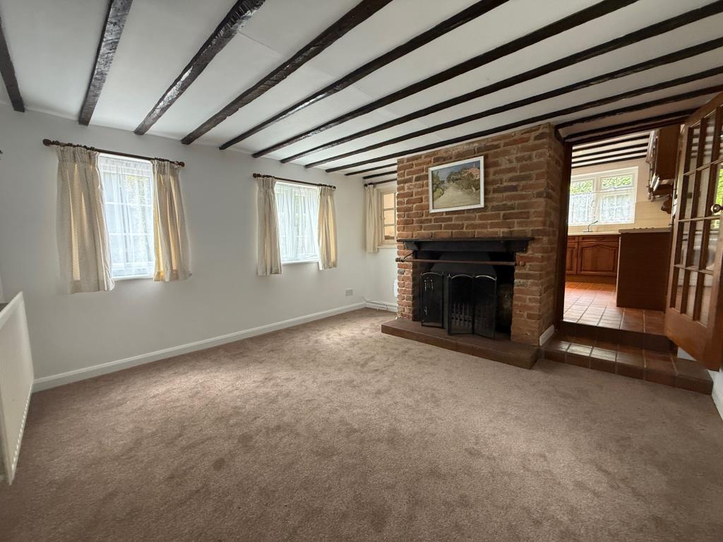 Lot: 150 - PERIOD COTTAGE FOR IMPROVEMENT - Reception room with open fire